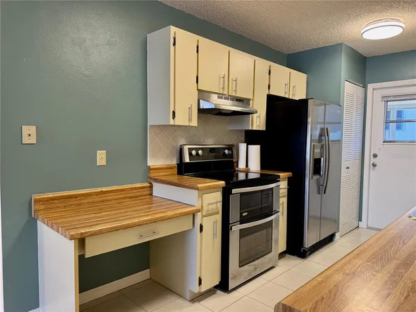 a kitchen with a stove and a refrigerator