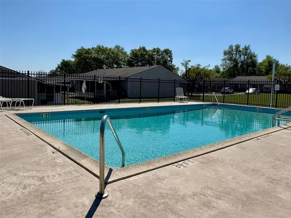 a view of a swimming pool with a lounge chairs