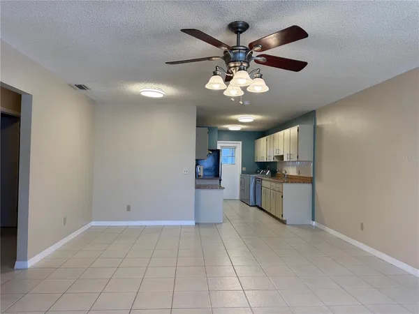 a view of a kitchen with a sink and stainless steel appliances