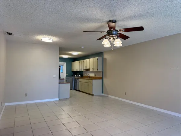 a kitchen with granite countertop a sink cabinets and stainless steel appliances