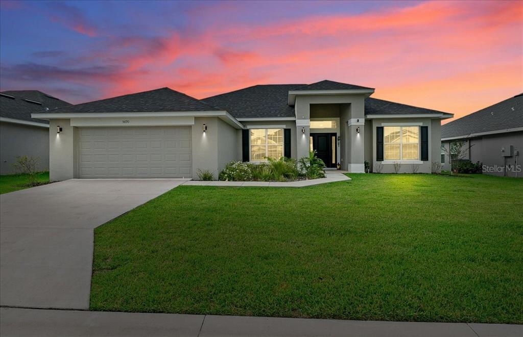 a front view of a house with a yard and garage