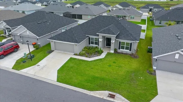 an aerial view of a house with a yard