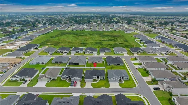 a front view of a house with a garden and yard