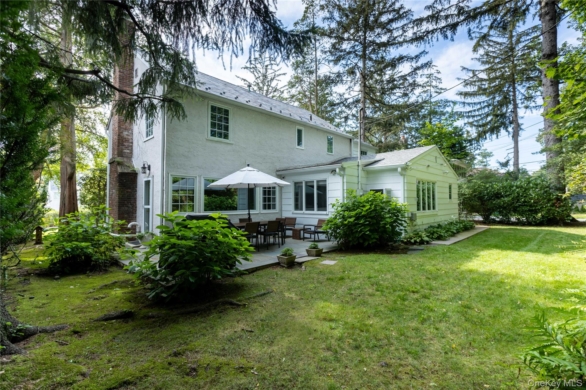 20 Mill Spring Road Manhasset, NY 11030 - Photo 17 of 17 a front view of a house with a yard
