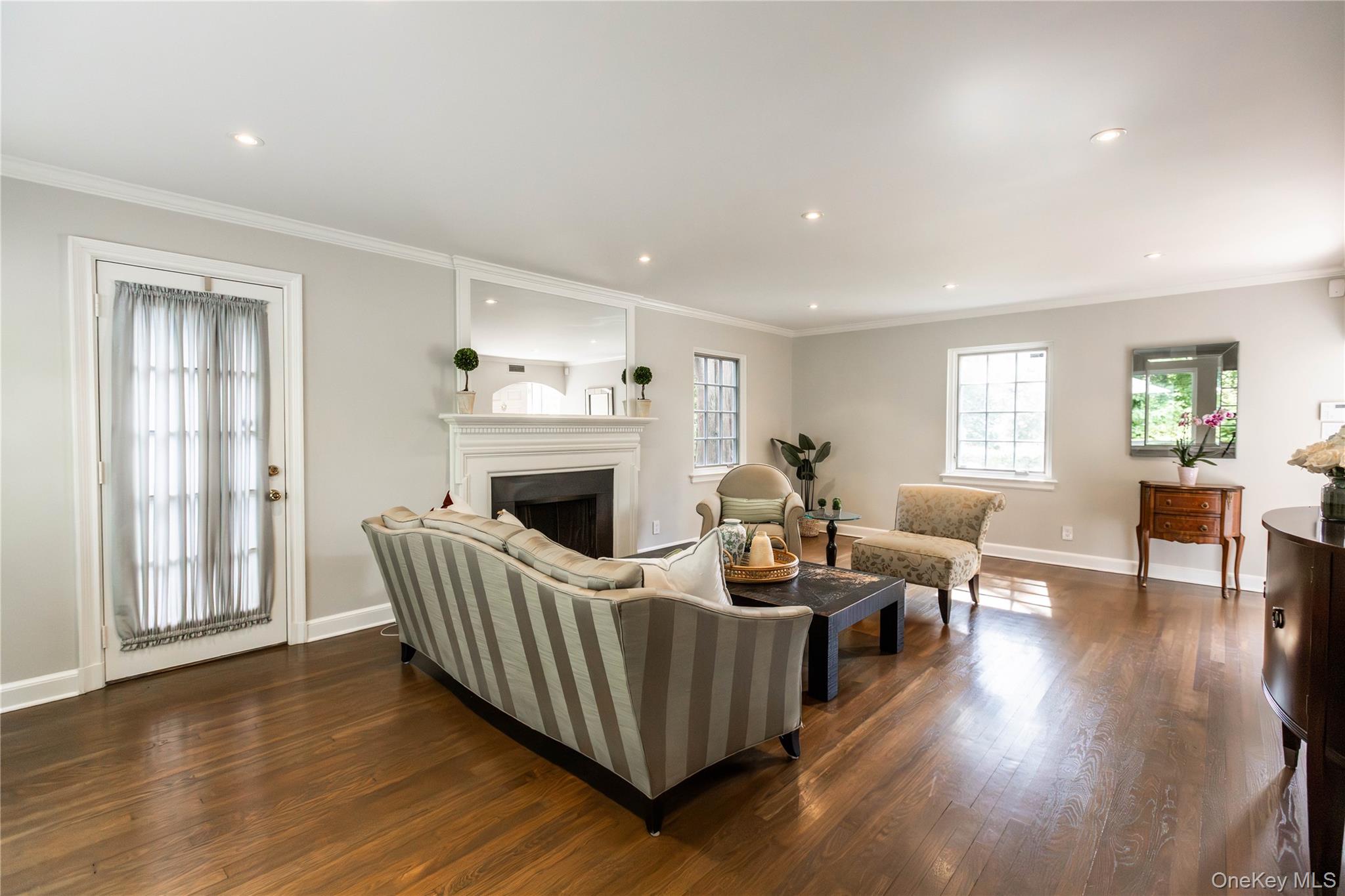 20 Mill Spring Road Manhasset, NY 11030 - Photo 4 of 17 a living room with furniture and a fireplace