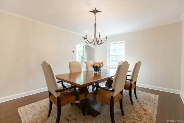 a view of a dining room with furniture and a chandelier