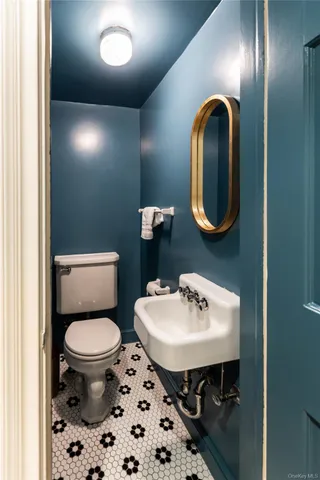 a bathroom with a sink a toilet and a mirror