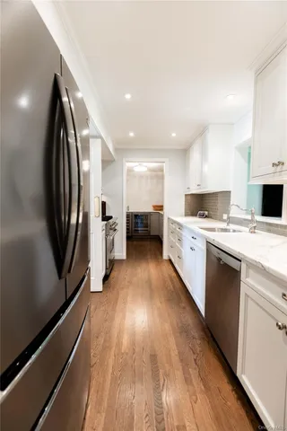 a kitchen with stainless steel appliances granite countertop a stove sink and refrigerator