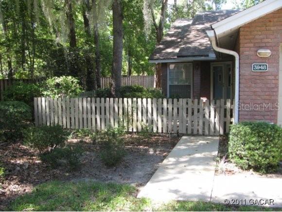 3948 Northwest County Road Gainesville, FL 32606 - Photo 1 of 1 a front view of a house with a garden