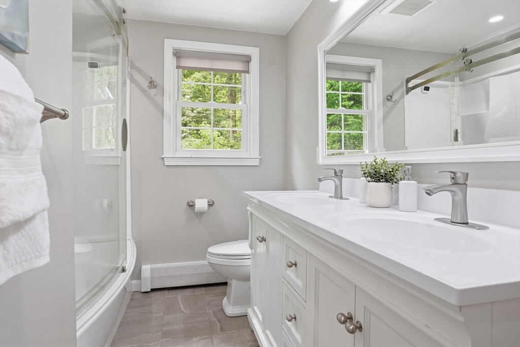 33 Simon Willard Road Acton, MA 01720 - Photo 16 of 42 a bathroom with a granite countertop toilet a sink and a bathtub