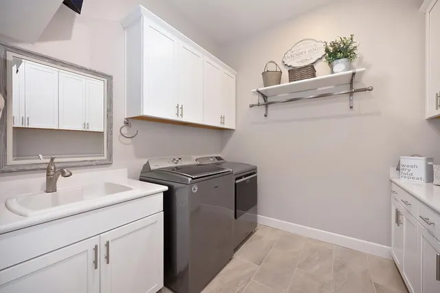 a kitchen with a sink cabinets and stove top oven