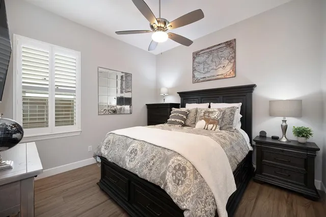 a bedroom with bed and wooden floor