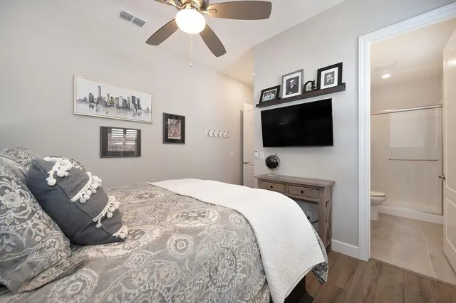 a bedroom with a bed and a flat screen tv