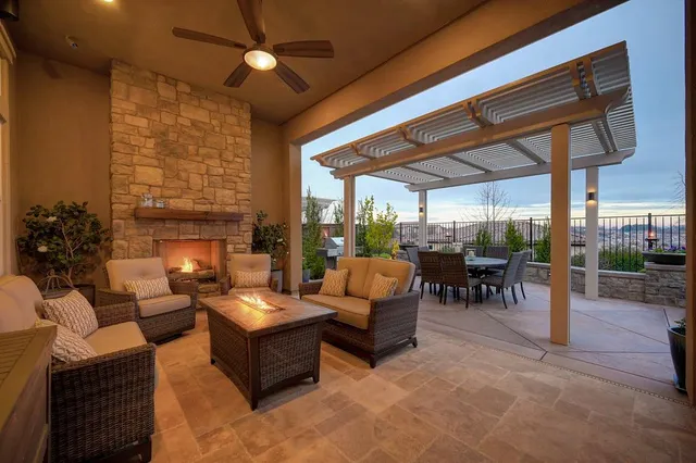 a living room with furniture a fireplace and a table