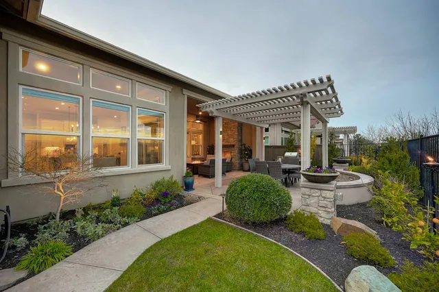 a view of a backyard with garden and patio