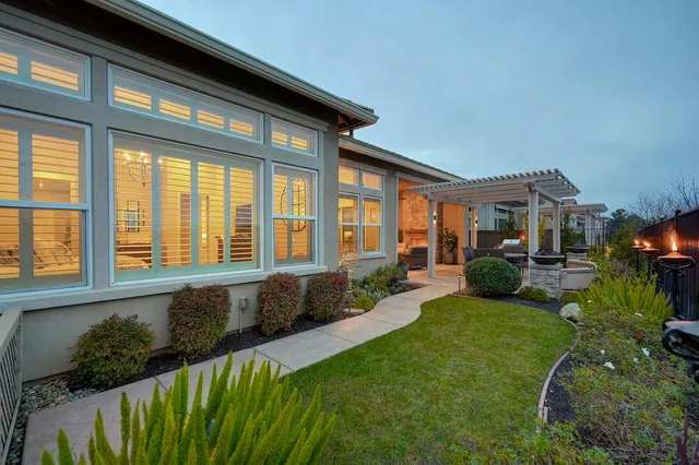 a front view of a house with a garden and patio