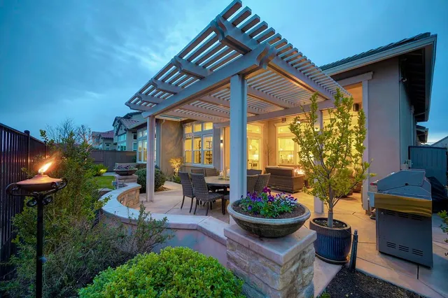 a view of a backyard with garden and patio