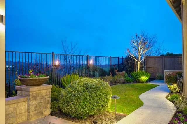 a view of a chair and table in backyard