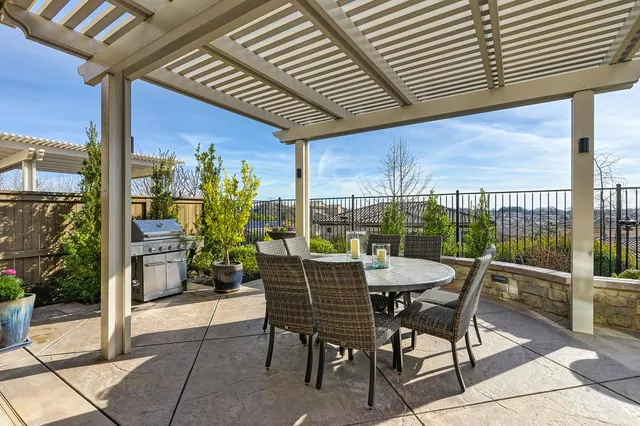 a dining room with furniture and garden view