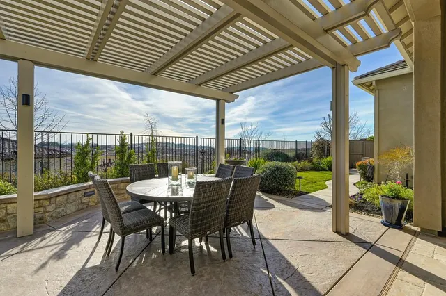 a view of a backyard with potted plants and a bench