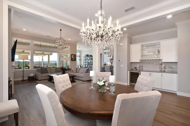 a living room with furniture a chandelier and a chandelier