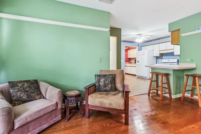 a living room with furniture and a wooden floor