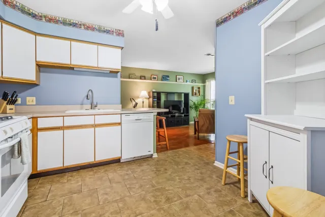 a kitchen with a sink a stove cabinets and counter space