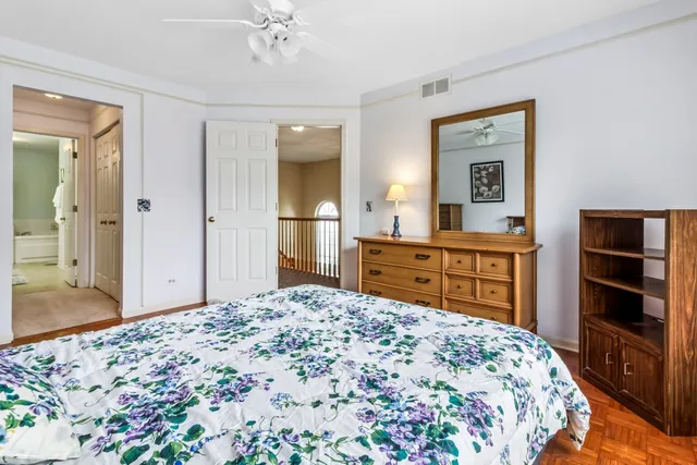 a bedroom with a bed and a dresser