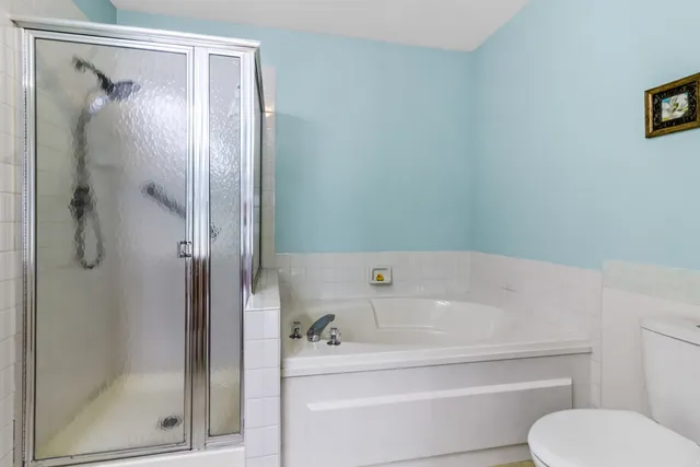 a bathroom with a tub and a shower