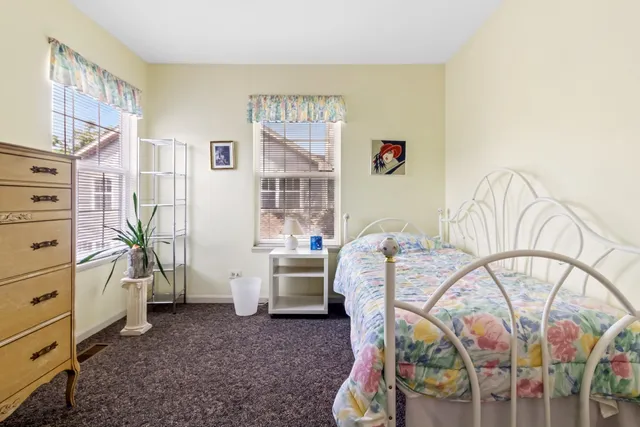 a bed room with a bed and a desk