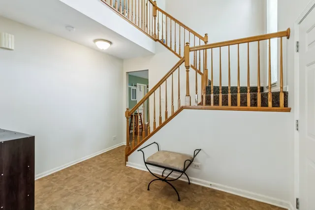 a view of a hallway with wooden floor and stairs