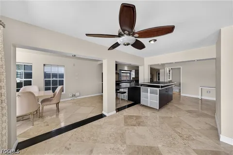 a kitchen with stainless steel appliances kitchen island granite countertop a stove and a refrigerator