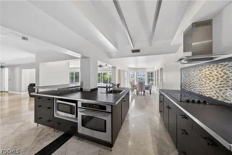a kitchen with stainless steel appliances granite countertop a stove and a sink