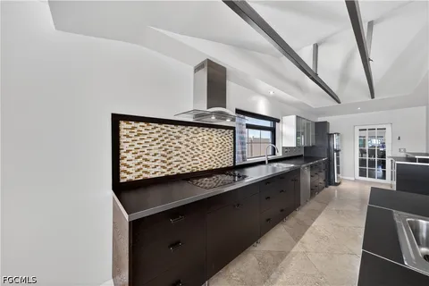 a kitchen with stainless steel appliances kitchen island granite countertop a stove and cabinets