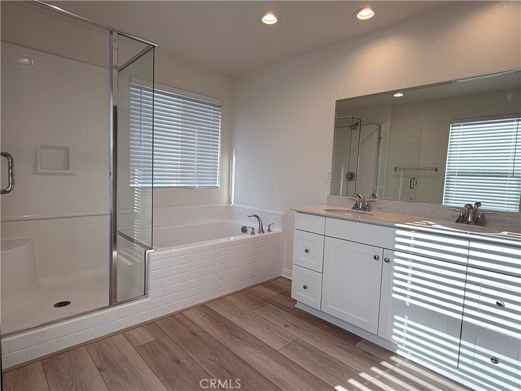 7631 Rubyred Gln Drive Riverside, CA 92507 - Photo 13 of 17 a bathroom with a double vanity sink mirror and shower