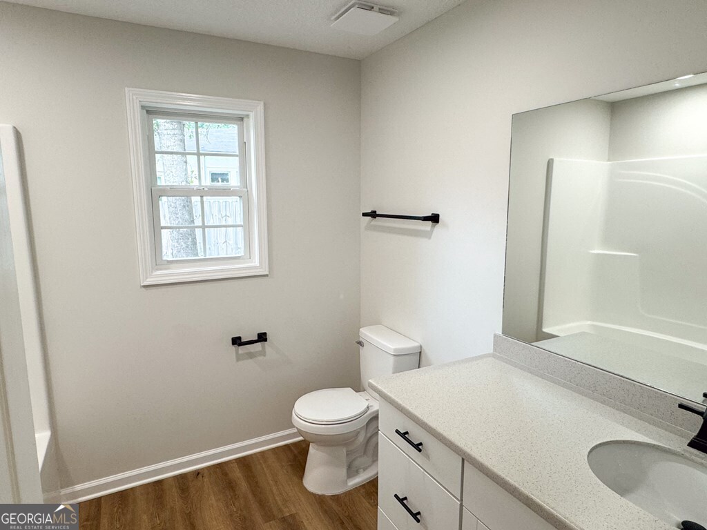 808 Satilla Boulevard Waycross, GA 31501 - Photo 17 of 29 a bathroom with a sink toilet and vanity