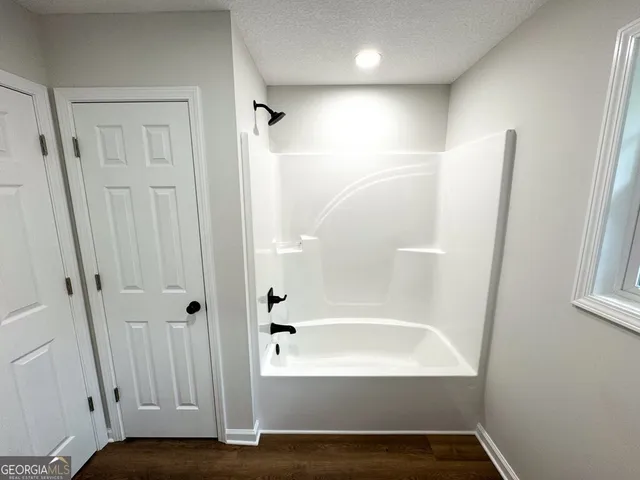 a spacious bathroom with a toilet sink and mirror