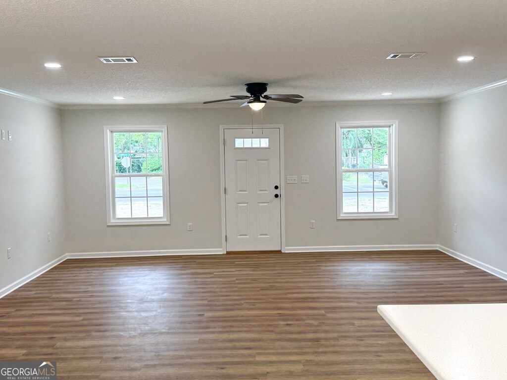 808 Satilla Boulevard Waycross, GA 31501 - Photo 2 of 29 a view of an empty room with a window and wooden floor