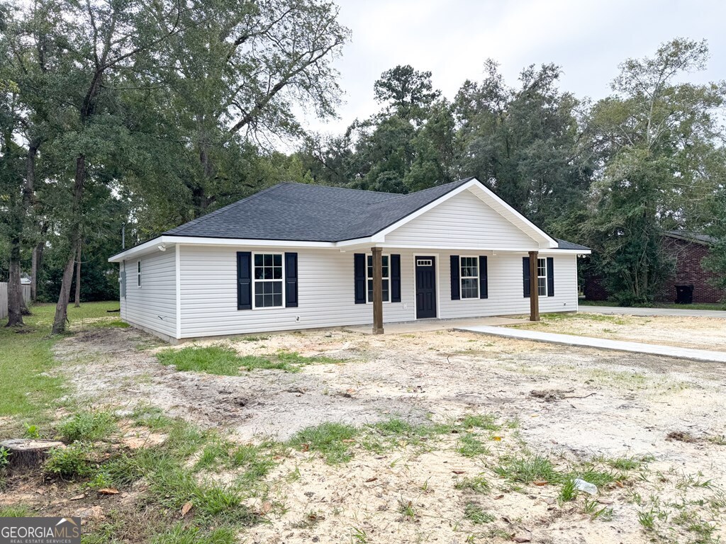 808 Satilla Boulevard Waycross, GA 31501 - Photo 25 of 29 a view of a yard in front of a house with large trees