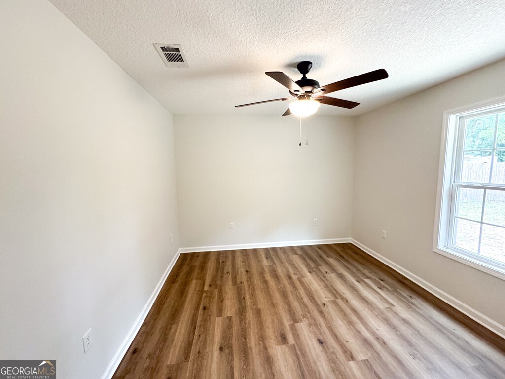 808 Satilla Boulevard Waycross, GA 31501 - Photo 28 of 29 an empty room with windows and fan