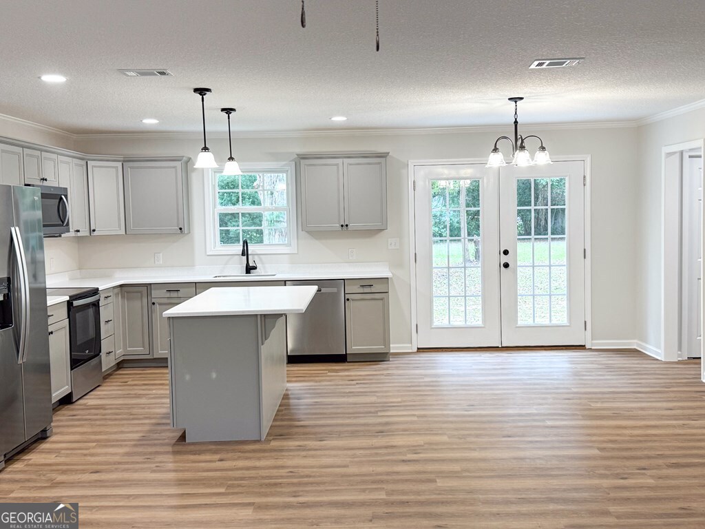 808 Satilla Boulevard Waycross, GA 31501 - Photo 4 of 29 a kitchen with stainless steel appliances granite countertop a sink cabinets and a wooden floor