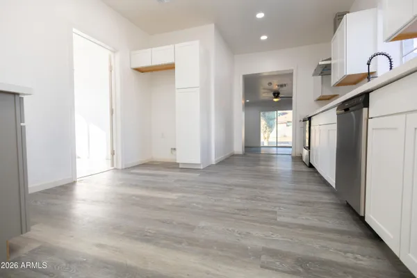 a view of a hallway with wooden floor