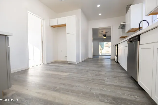 a view of a hallway with wooden floor