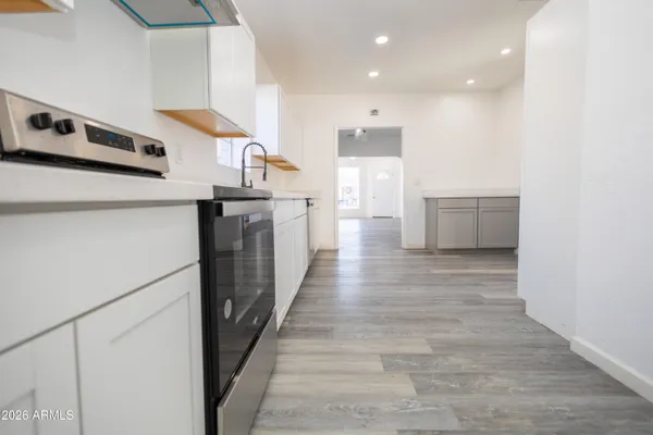a kitchen with stainless steel appliances granite countertop a refrigerator and a stove