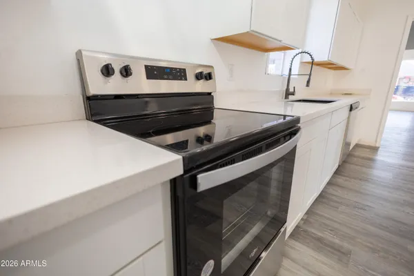 a kitchen with granite countertop a stove and a sink