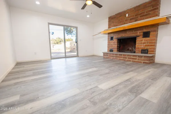 a living room with stainless steel appliances wooden floor