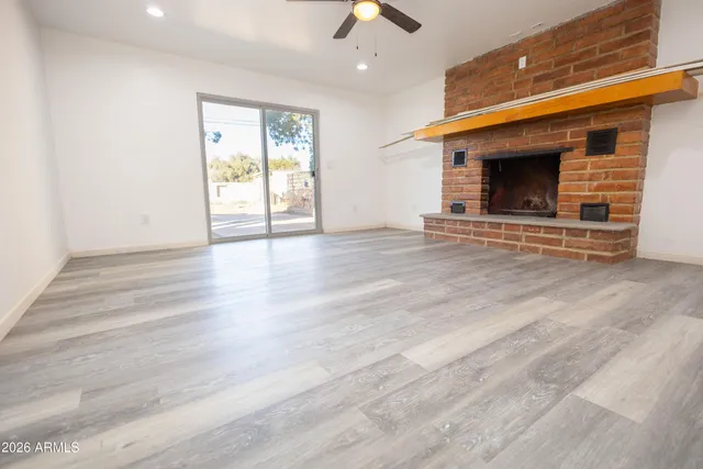 a living room with stainless steel appliances wooden floor