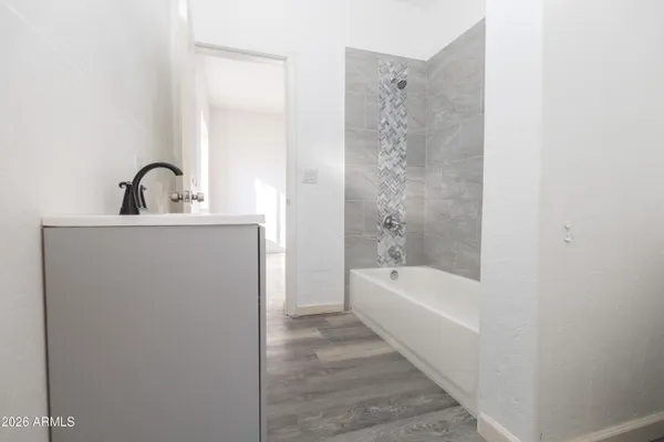 a bathroom with a bathtub and shower
