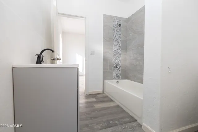 a bathroom with a bathtub and shower