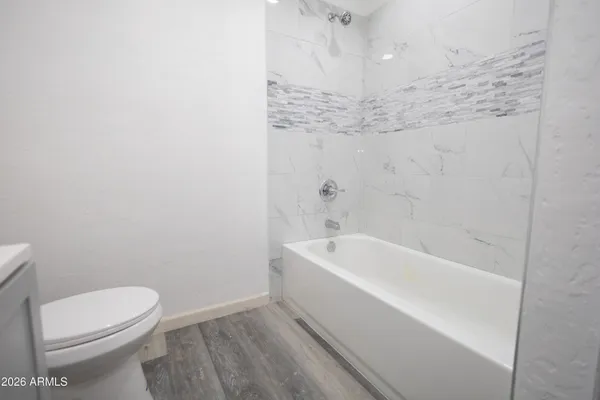 a bathroom with a sink a toilet and with mirror